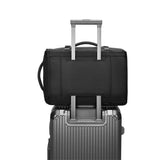 Safe & Save Bag™ on top of a gray suitcase, showcasing its travel-friendly design and convenience.